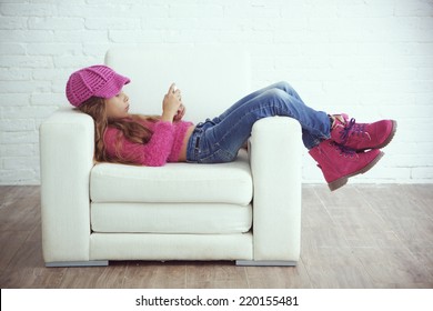 Cute Pre-teen Girl Wearing Fashion Winter Clothes Posing In White Interior