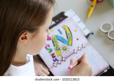 Cute Preteen Little Girl Writing Her Dreams In Diary. View From Top