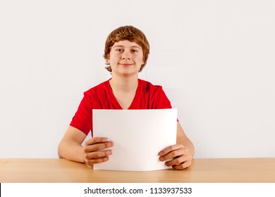 cute pupilin in red shirt holding a poster - Powered by Shutterstock