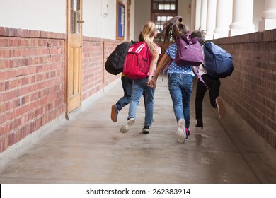 Cute Pupils Running Down The Hall At The Elementary School