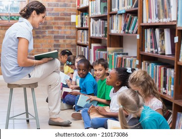 Cute Pupils Sitting On Floor In Library At The Elementary School