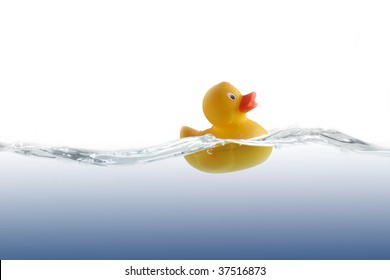 Cute Rubber Duckling In Undulate Water.