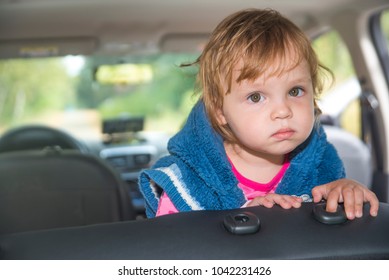 Cute Sad Cauasian Little Child Girl Sitting In The Car And Look Out From The Car Window In The Sunny Summer Day. Alone Kid Baby Girl