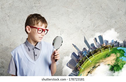 Cute school boy examining objects with magnifying glass. Elements of this image are furnished by NASA - Powered by Shutterstock