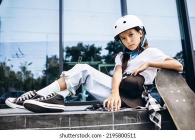 Cute School Girl Skating On Skate Board In The City Wearing Safety Helmet