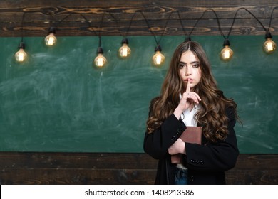 Cute schoolgirl posing solving problem on blackboard. Dating. Teenager school. Blonde woman near blackboard