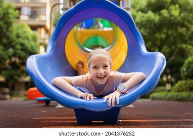 Cute schoolgirl walking outdoor on playground at summer. Lonely during covid-19 quarantine. Child can't play with friends while coronavirus pandemic. - Powered by Shutterstock