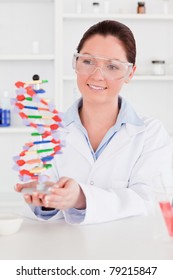 Cute Scientist Showing The Dna Double Helix Model