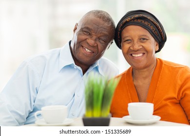 cute senior african couple portrait at home