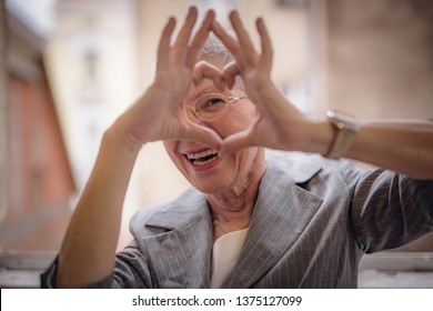 Cute Senior Old Business Woman Making A Heart Shape With Her Hands And Fingers