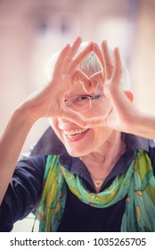 Cute Senior Old Woman Making A Heart Shape With Her Hands And Fingers