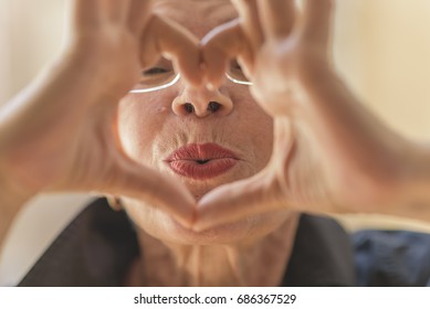 Cute Senior Old Woman Making A Heart Shape With Her Hands And Fingers