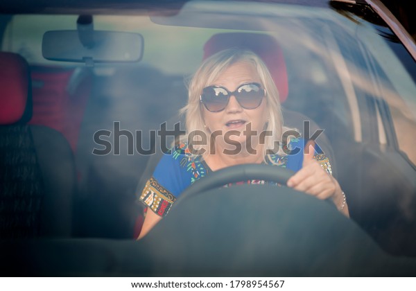 Cute senior woman driving
the car