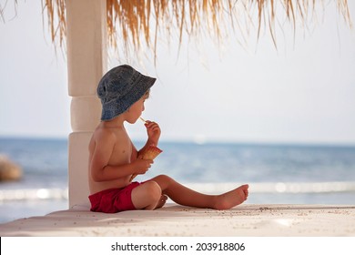 Cute Shirtless Boy, Eating Red Ice Cream On The Beach