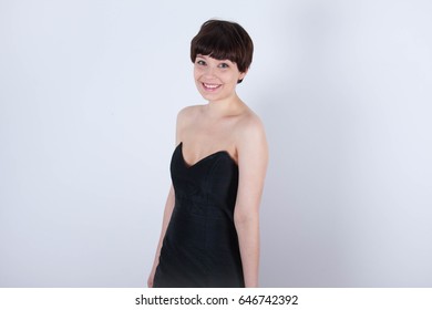 Cute Short Haired Model In Vintage Designer Minimal Prom Dress. Mod, Retro Style. Studio Fashion Shots. Model Is Wearing Her Mom's Prom Dress From The 80's. 