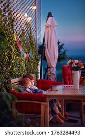 Cute Siblings Having Fun, Watching Cartoons On The Phone, Spending Time On Cozy Rooftop Patio On Summer Evening