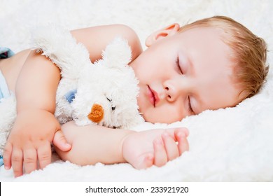 Cute sleeping child with teddy bear