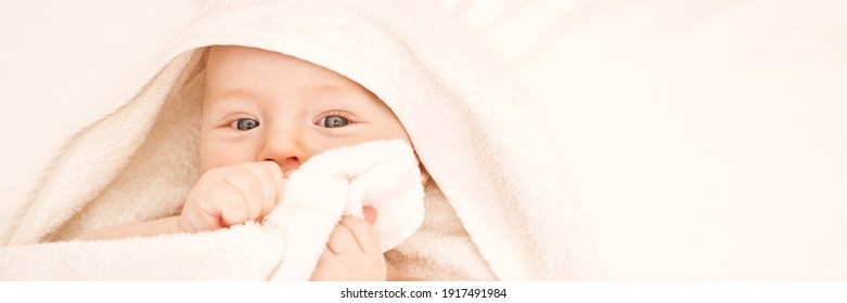 Cute Small Boy Lying At Bed. Childhood Bath Concept. Light Background. Little Child. Serious Emotion. Copyspace. Stay Home. Towel Mockup. Hide From Mom. Horizontal Banner