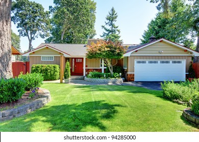 Cute Small Brown Rambler House With Red Door And White Garage Door