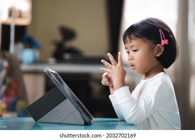 Cute small Girl Counting Her Fingers While learning Mathematics online. - Powered by Shutterstock