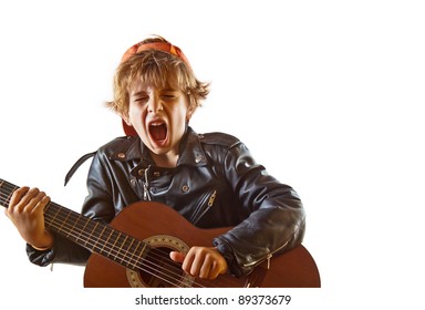 Cute Small Kid Playing Guitar With Great Concentration And Attitude. White Background, Plenty Of Copy Space.