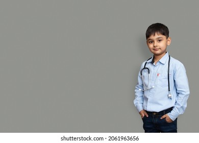 Cute Small Pakistani Asian Kid Boy Wear White Shirt With Stethoscope Playing Doctor, Happy Funny Little Mixed Race Preschool Child Pretending Pediatri