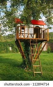 Cute Small Tree House For Kids On Backyard. German Style.