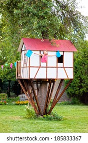 Cute Small Tree House For Kids On Backyard. Girl Inside.