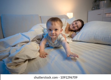 Cute Smiling Baby Crawling On Bed Towards Camera