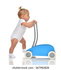 Cute Smiling Baby Girl Toddler With Toy Walker Make First Steps Isolated On A White Background 