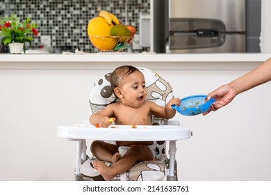 Cute Smiling Baby Holding Plate Of Food, Hand Delivers Empty Plate To Hand, Boy Sitting On High Chair, Baby Food, Early Childhood