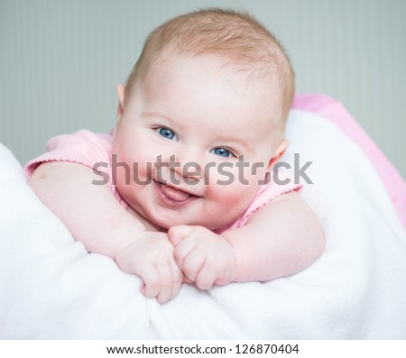 cute smiling baby  lye on a bed close-up