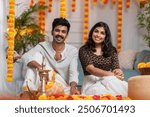 Cute smiling couple celebrating Onam festival by making flower decoration, Happy Onam greeting image, South Indian couples wearing traditional dress on the occasion of Onam