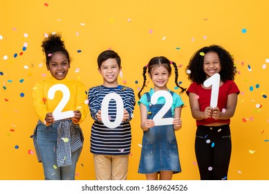 Cute Smiling Diverse Kids Showing Numbers 2021 Celebrating New Year Isolated On Yellow Background