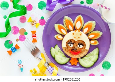 Cute Smiling Face  Of A Rio Carnival Dancer Made Of A Sandwich With Cheese And Fresh Vegetables Like Cucumbers And Carrots, Served With A Glass Of Milk. Healthy Lunch Of Snack For Kids