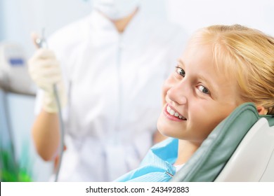 Cute Smiling Girl In At Dentist Sitting In Armchair