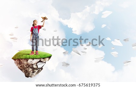 Cute smiling girl sitting on floating island high in sky