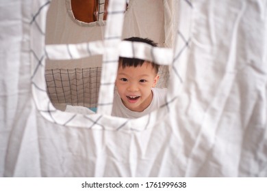 Cute Smiling Happy Asian Little Schoolboy Having Fun Playing In Kids Tent Or Teepee At Home