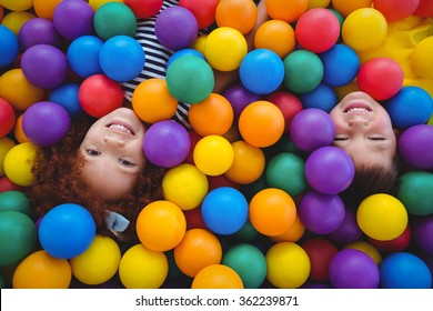 Cute Smiling Kids In Sponge Ball Pool Looking At Camera