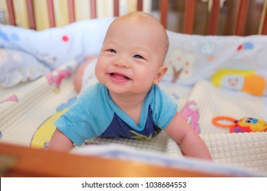 Cute Smiling Little Asian 5 - 6 Months Old Baby Boy Child At Tummy Time In Baby Cot / Crib In Bedroom At Home Day Time; Newborn Child Relaxing. Nursery For Young Children. Soft And Selective Focus