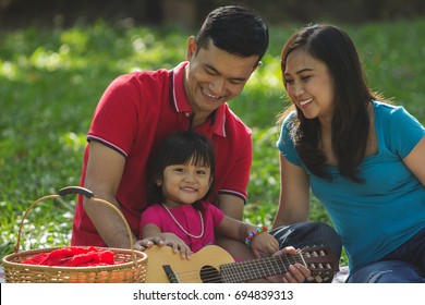 Cute Smiling Little Girl Having A Family Outing With Her Parents