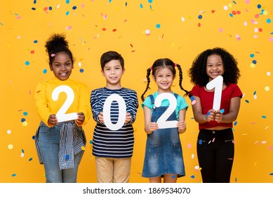 Cute Smiling Mixed Race Kids Showing Numbers 2021 Celebrating New Year Isolated On Yellow Background