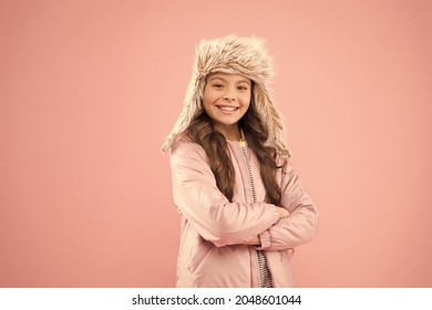 Cute Smiling Model. Adorable Small Child Wear Winter Knitted Accessory. Cute Little Girl Fashion Hat Pink Background. Clothes Shop. Hats For Winter Season. Winter Outfit. Shopping For Accessories