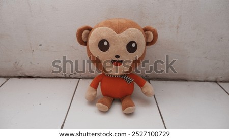 Cute smiling monkey doll sitting