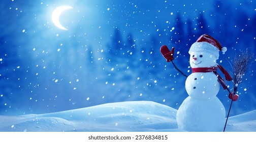 Cute smiling snowman with red scarf and hat with a broom in his hand. A winter Christmas landscape with the moon.Merry christmas and happy New Year greeting card with copy-space - Powered by Shutterstock