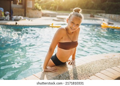 Cute Smiling Teen Girl Enjoying A Summer Vacation At The Swimming Pool.