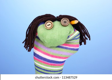 Cute Sock Puppet On Blue Background