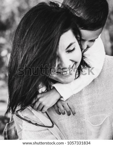 cute son with sunglasses hug smiling happy mother, mom and kid