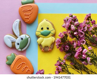 Cute spring background with flowers and a chick in a face protective mask 