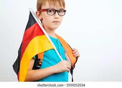 Cute student holding german flag. People, education, learning and school concept. Kid kearning German. Immigration to Germany. Lessons and learning of foreign languages. Foreign language school.